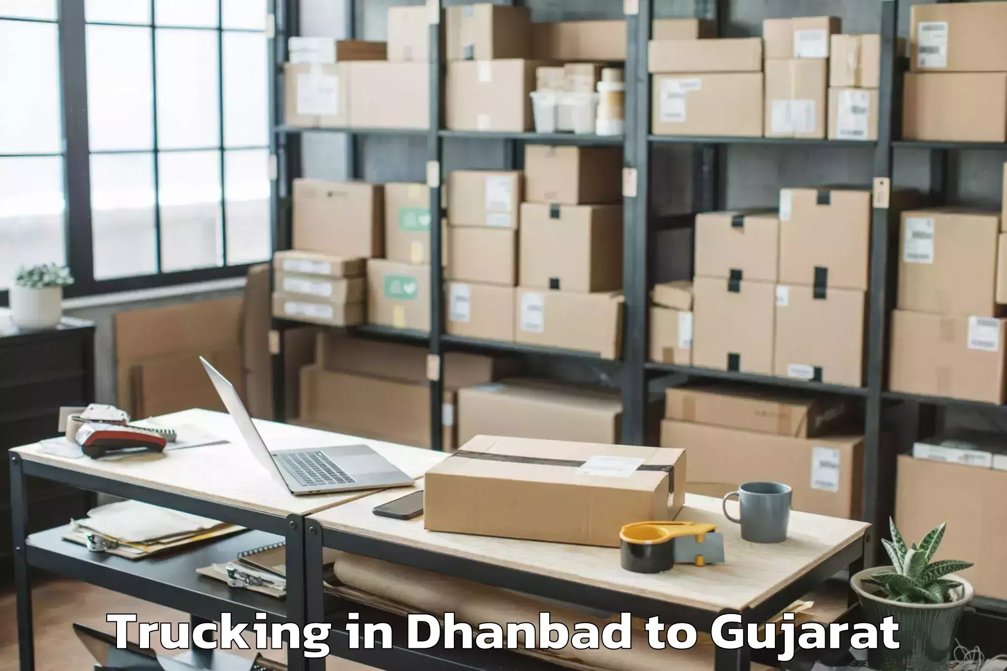 Expert Dhanbad to Kamrej Trucking